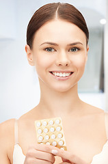 Image showing young beautiful woman with pills