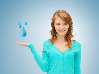 Image showing woman showing blue water drops