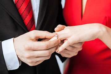 Image showing man putting  wedding ring on woman hand