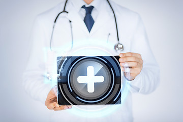 Image showing male doctor holding tablet pc with medical app