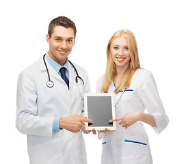 Image showing young doctors pointing at tablet pc