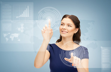 Image showing businesswoman touching virtual screen