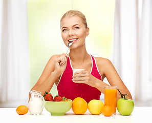 Image showing young woman eating healthy breakfast