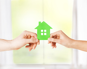 Image showing couple hands holding green house