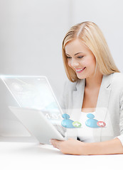 Image showing businesswoman looking at tablet pc