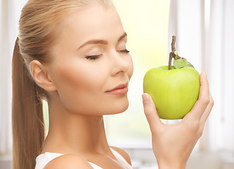 Image showing woman smelling apple