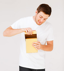 Image showing man in white t-shirt with gift box