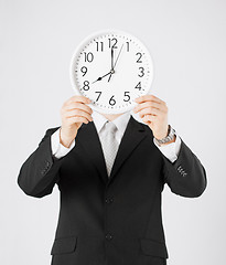 Image showing man with wall clock