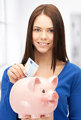 Image showing lovely woman with piggy bank and money