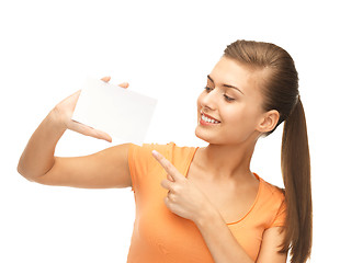 Image showing smiling woman pointing at white blank card