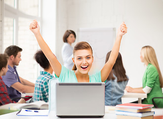 Image showing happy student girl with laptop at school