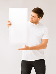 Image showing young man holding white blank board