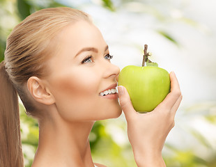 Image showing woman smelling apple