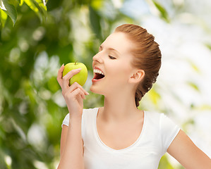 Image showing woman with green apple at countryside