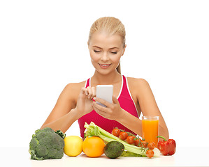 Image showing woman with fruits, vegetables and smartphone