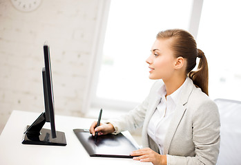 Image showing businesswoman with drawing tablet in office