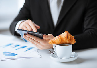 Image showing man with tablet pc and cup of coffee