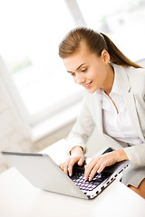 Image showing businesswoman with laptop in office