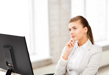 Image showing pensive woman in office