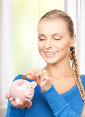 Image showing lovely woman with piggy bank and money