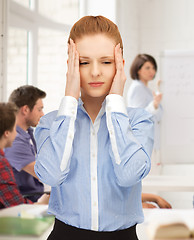 Image showing girl with headache at school