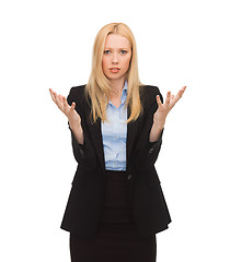 Image showing young confused businesswoman with hands up