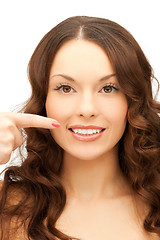 Image showing woman pointing at her toothy smile