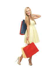 Image showing woman with shopping bags in dress and high heels