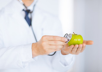 Image showing male doctor with green apple and stethoscope