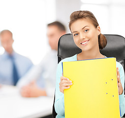 Image showing young attractive businesswoman with folders