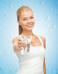 Image showing young smiling woman with glass of water