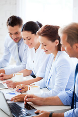 Image showing group of people working with laptops in office