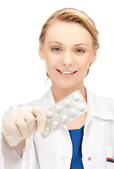 Image showing female doctor with one pack of pills