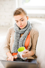 Image showing diseased woman in scarf using laptop at home