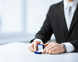 Image showing man with gift box and wedding ring