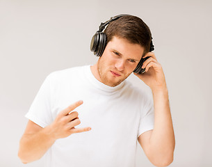 Image showing man with headphones listening rock music