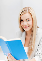 Image showing young woman reading book