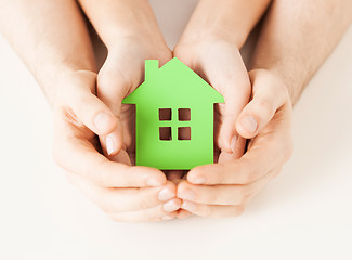 Image showing couple hands holding green house