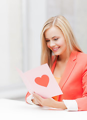 Image showing woman holding postcard with heart shape