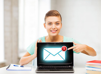 Image showing smiling student girl with laptop at school