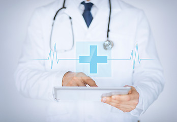 Image showing male doctor holding tablet pc with medical app