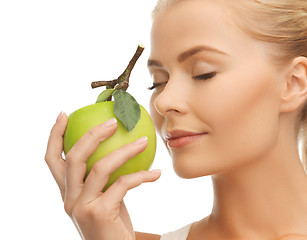 Image showing woman smelling apple