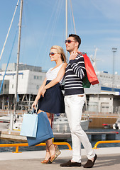 Image showing young couple in duty free shopping bags