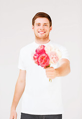 Image showing young man holding bouquet of flowers