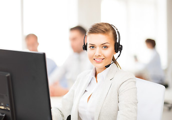 Image showing helpline operator with headphones in call centre