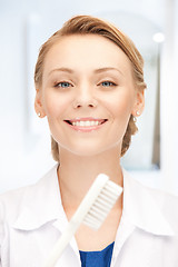 Image showing attractive female doctor with toothbrush