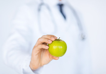 Image showing male doctor with green apple