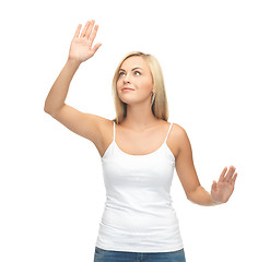 Image showing woman in white t-shirt pressing imaginary button