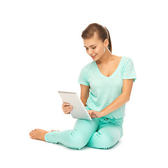 Image showing young girl sitting on the floor with tablet pc