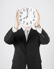 Image showing man with wall clock